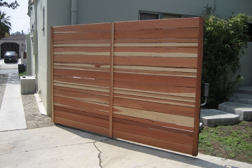 Swing gate with horizontal Redwood boards.